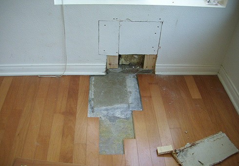 BEFORE: Floor and Wall Damaged by Pipe Leak